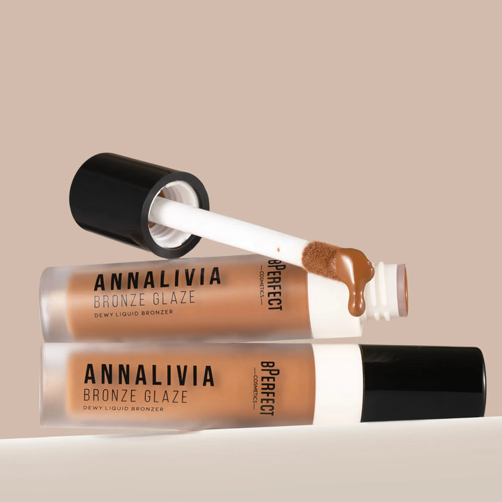 Two Annalivia Bronze Glaze bronzer products with a beige background