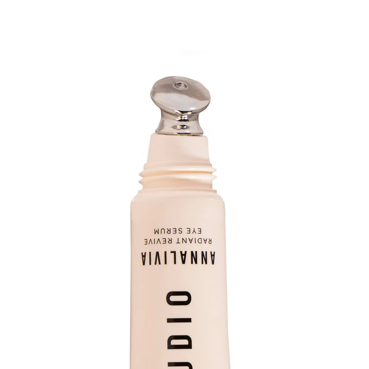 Skincare bottle with silver applicator on a white background