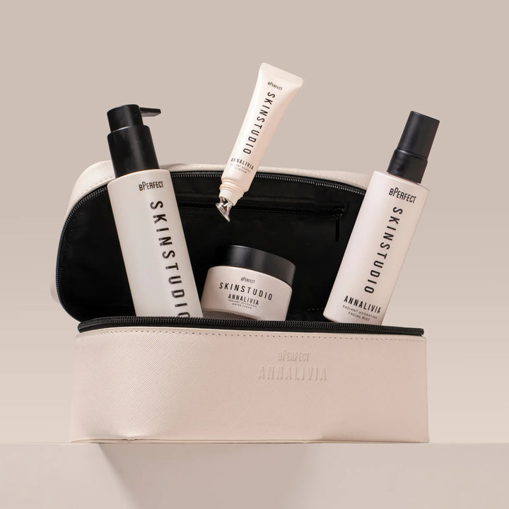 Set of skincare products from Annalivia Skin Studio in a beige pouch on a light background