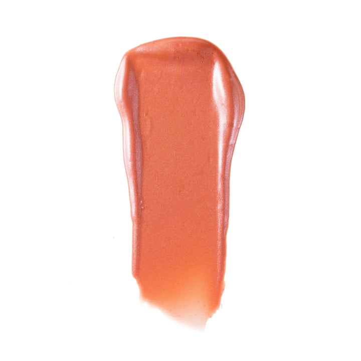 Peach-pink liquid blush swatch on a white background