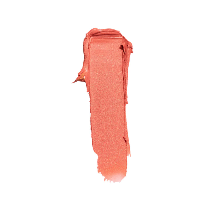 Coral-colored cream swatch on a white background
