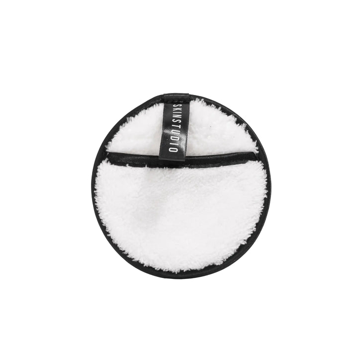 Round white cleaning pad with black border on a white background
