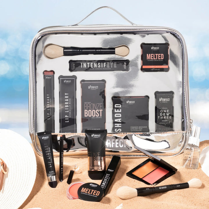 Clear makeup bag with cosmetic products on a beach background