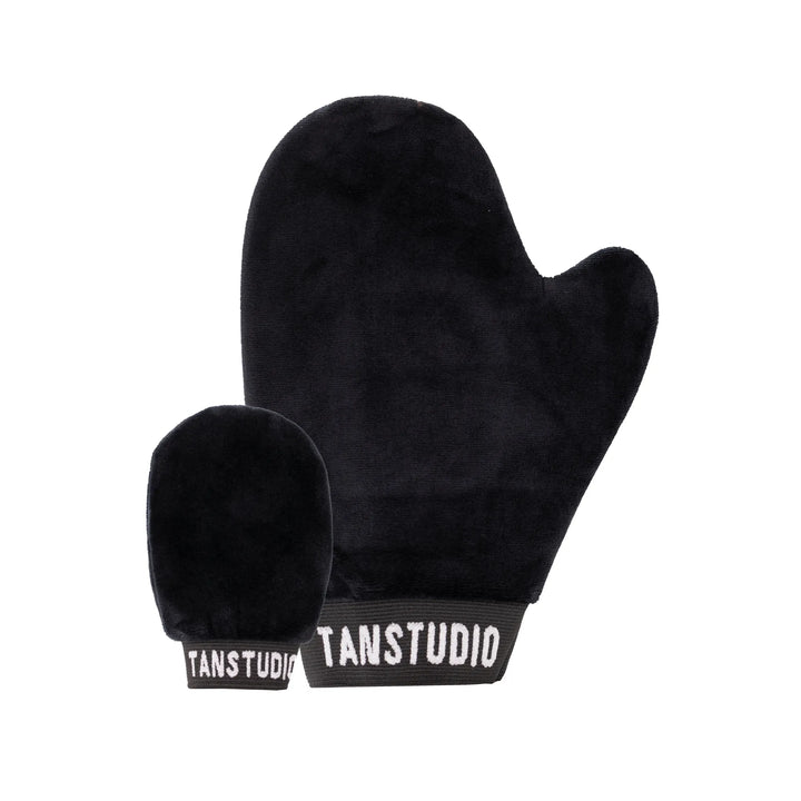 Black tanning mitt with 'TANSTUDIO' branding on a white background