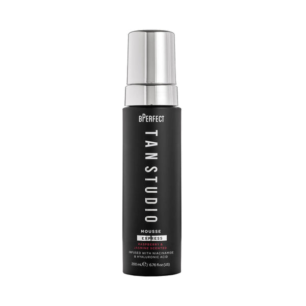 Black bottle of BPerfect Tan Studio Mousse with silver cap on a white background