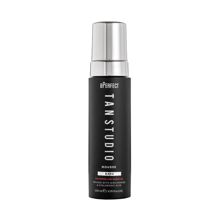 Black bottle of BPerfect Tan Studio Mousse with silver cap on a white background