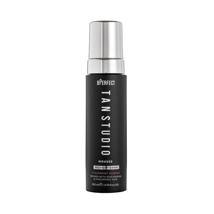 Black bottle of BPerfect Tan Studio Mousse with silver cap on a white background