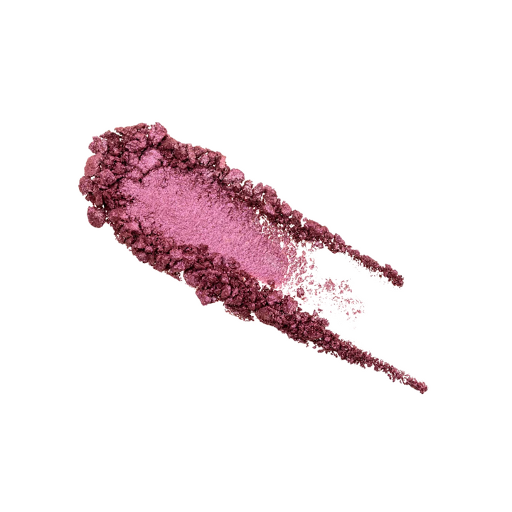 Pink makeup powder swatch on a white background